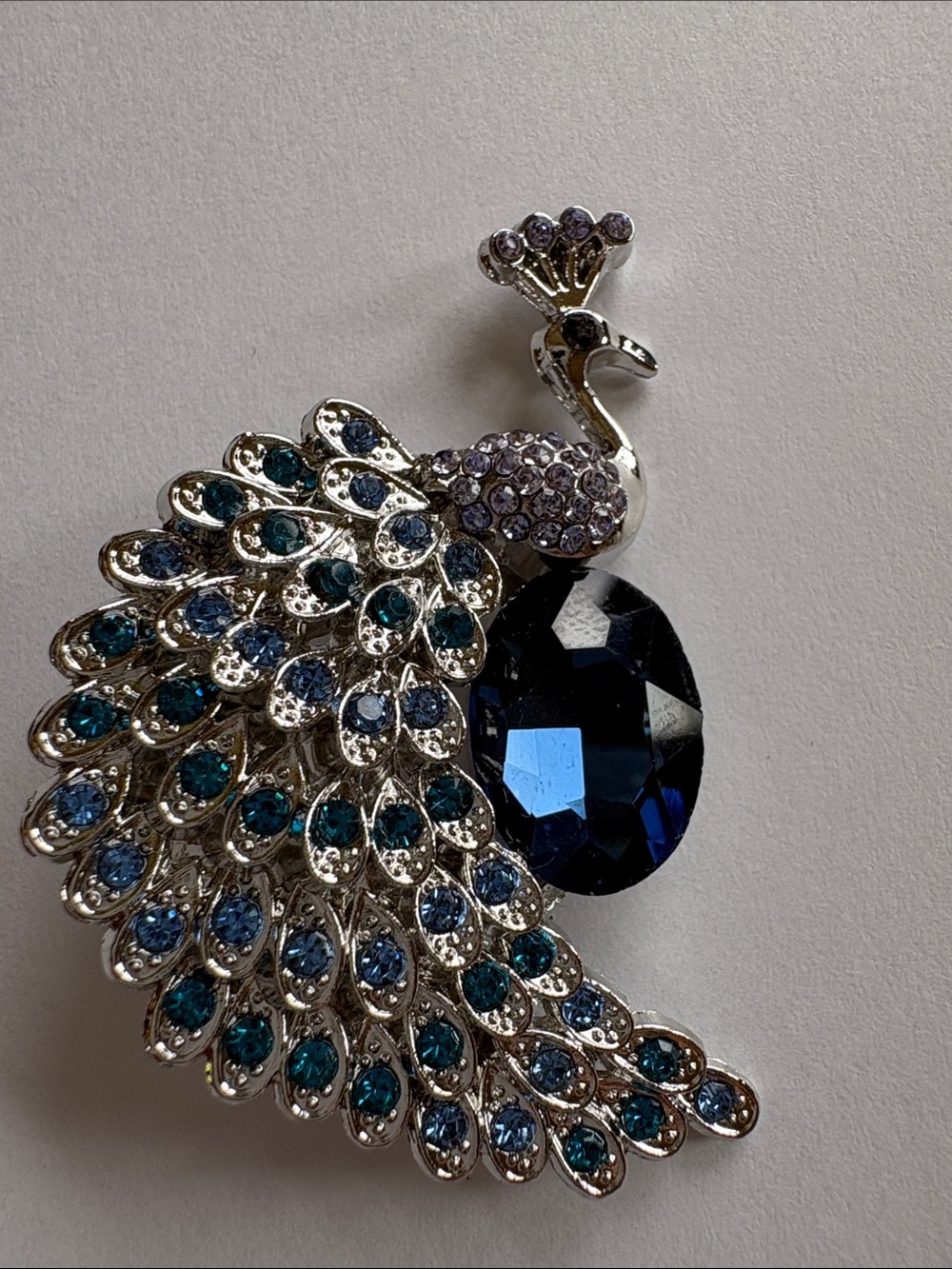Silver Peacock Brooch with Deep Blue Crystal Accent